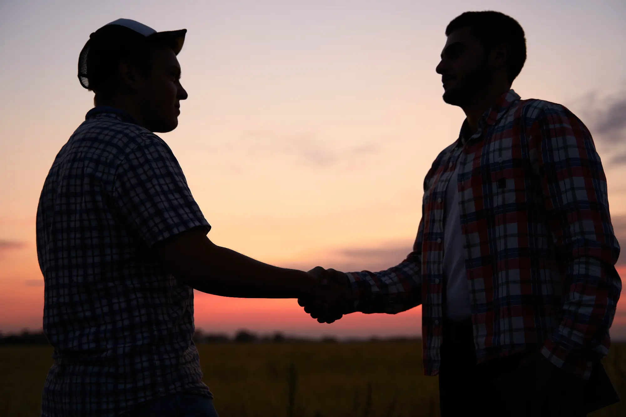Photo of farmers shaking hands.